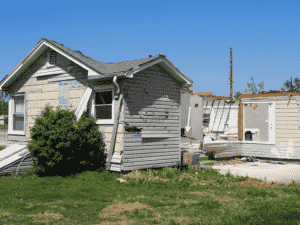 an image from the 2022 andover tornado showing a house with destroyed roof