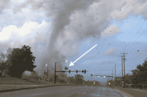 image from the 2022 andover tornado showing a home's roof in the flying debris