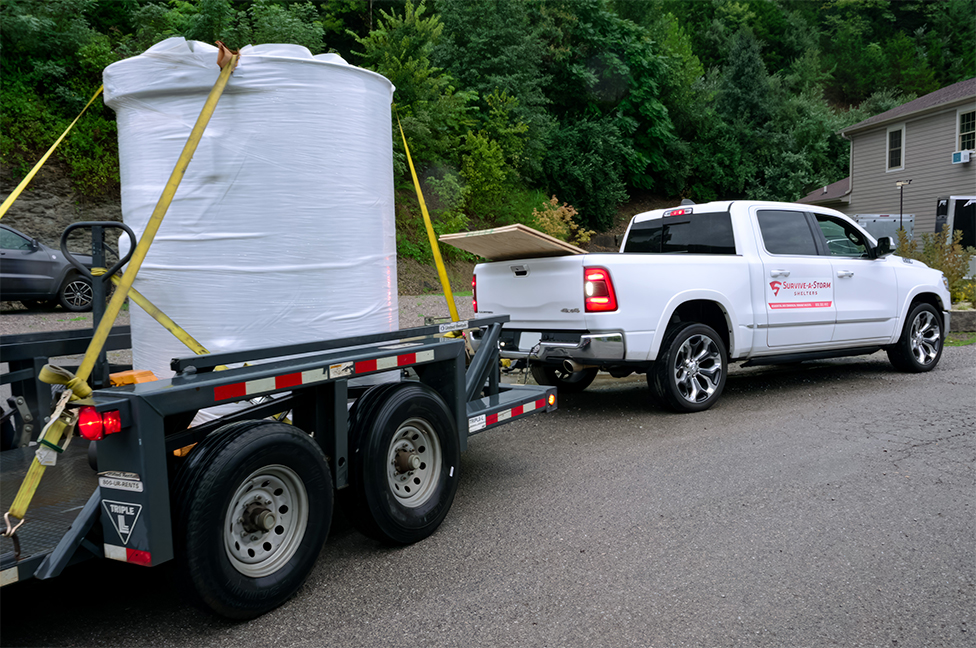 A Twister Pod tornado shelter loaded on the back of a trailer for delivery.