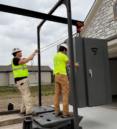 icc 500 tornado shelter installation Crew installing an above-ground tornado shelter during residential construction.