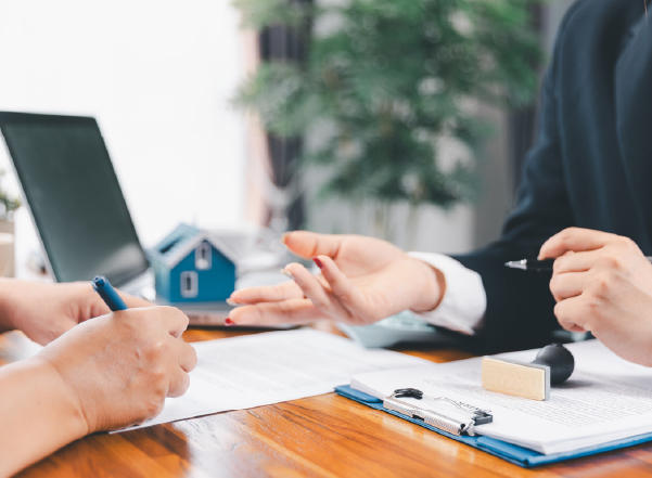 Homebuyer reviewing paperwork and discussing storm shelter details during a real estate transaction.
