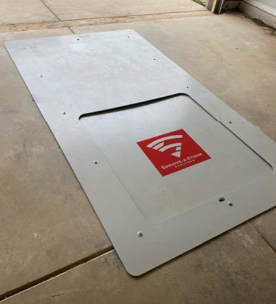 tornado shelter garage in ground An image of the GarageCube, an in-ground residential storm shelter installed in a garage floor with a flush-mounted access door.
