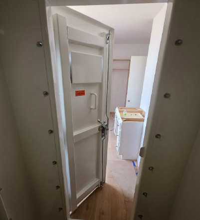 indoor tornado shelter installation interior Interior view of an above-ground tornado shelter after installation inside a home