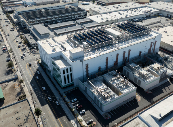 data centers outside Aerial view of a large data center facility with rooftop cooling and mechanical equipment.