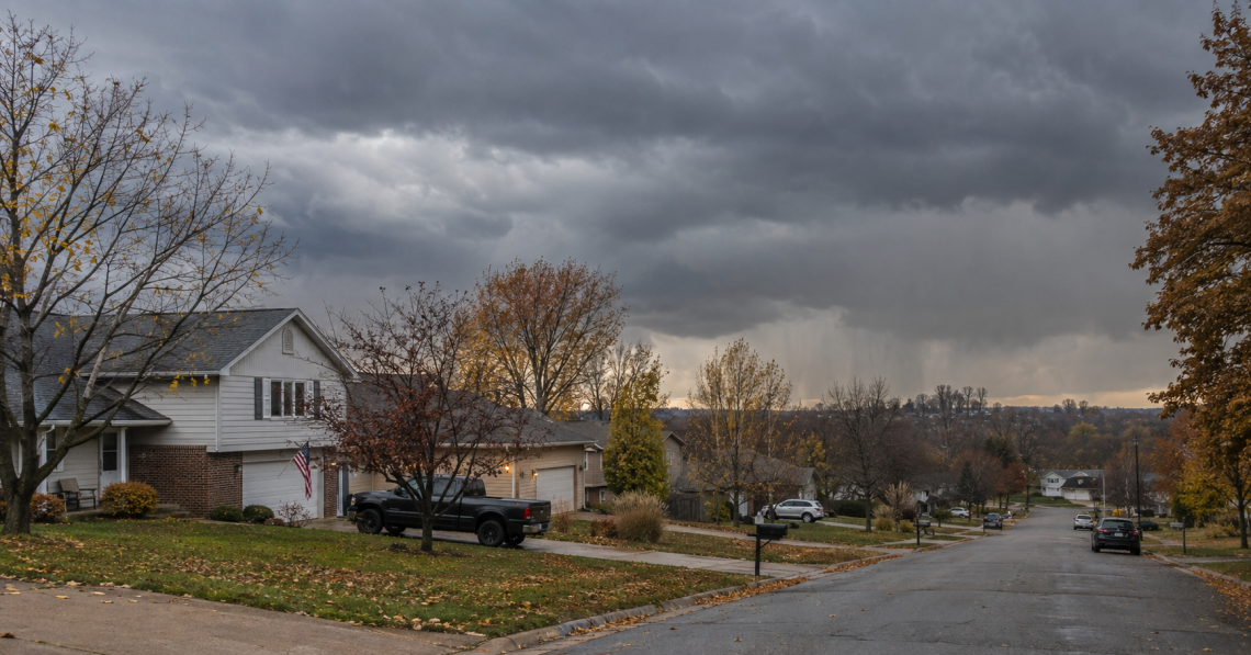 Dark storm clouds approaching homes during fall tornado season